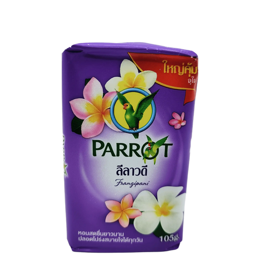 Parrot Botanicals Parrot Herbal Soap Frangipani Scent - 105g features purple packaging with vibrant yellow and white flowers, exuding a delightful frangipani fragrance. Thai text and a parrot logo highlight authenticity, while Thai herbal extracts promise a soothing experience.