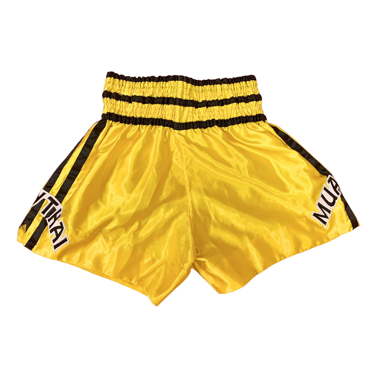 A pair of Red Bull Charge Muay Thai boxing shorts with black and yellow stripes at Hanuthai's Gym.