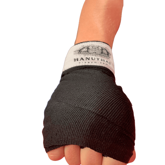 A person's hand wrapped in a Hanuthai Muay Thai Hand Wrap - Black for combat sports.