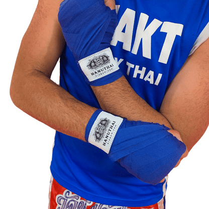 A man wearing Hanuthai blue Muay Thai Hand Wraps with Velcro Closure.