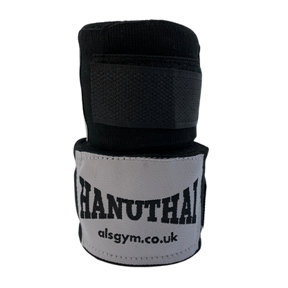 The black Muay Thai Hand Wraps by Hanuthai are ideal for boxing, featuring the "HANUTHAI" logo and "alsgym.co.uk" on a light gray patch.