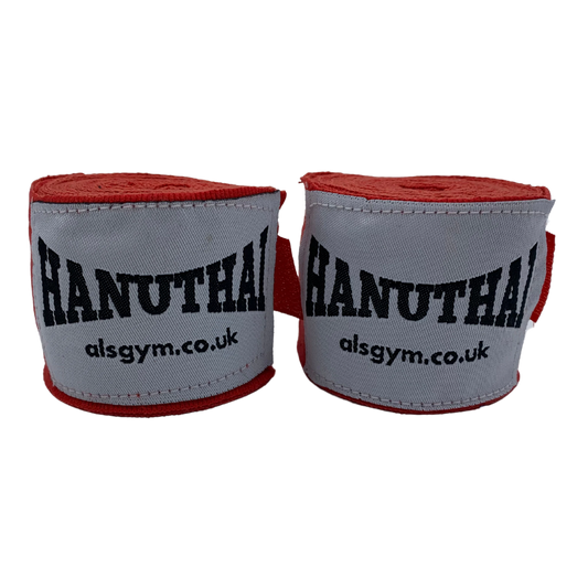 The Muay Thai Hand Wraps in red, by Hanuthai, feature "HANUTHAI" and "alsgym.co.uk" on white fabric. They are perfect for combat sports enthusiasts and designed with a secure Velcro closure for a snug fit.